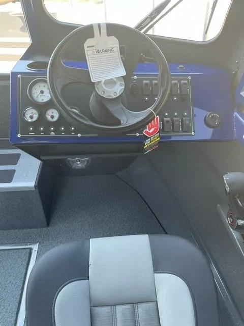 Slide: The Image of Interior of 2025 Spartan 240 Maximus Pro, featuring steering wheel and control panel. - 13