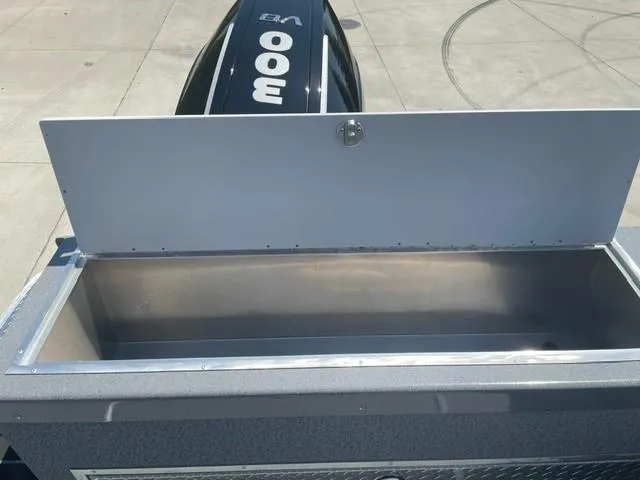 Slide: The Image of Open storage compartment on a 2025 Spartan 240 Maximus Pro boat, with a 300 HP engine. - 17