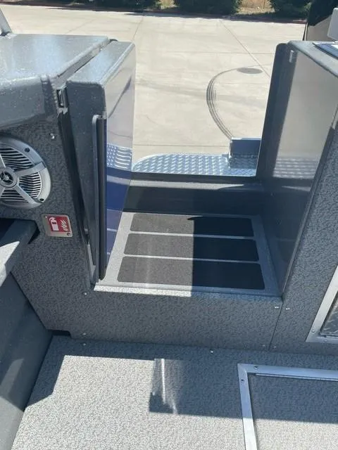 Slide: The Image of 2025 Spartan 240 Maximus Pro boat interior with non-slip flooring and speaker system. - 2