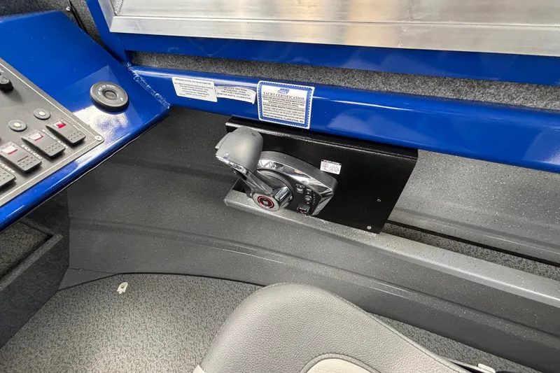 Slide: The Image of Control panel of 2025 Spartan 240 Maximus Pro boat with throttle lever and switches. - 42
