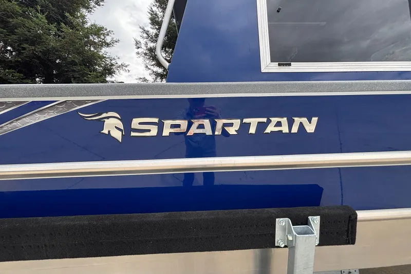 Slide: The Image of 2025 Spartan 240 Maximus Pro boat with blue exterior and silver logo detailing. - 10