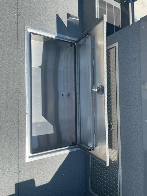 Slide: The Image of Open storage compartment on 2025 Spartan 240 Maximus Pro vehicle. - 5