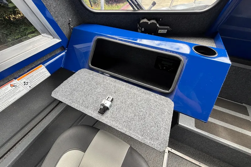 Slide: The Image of Interior of 2025 Spartan 240 Maximus Pro boat with open storage compartment. - 22