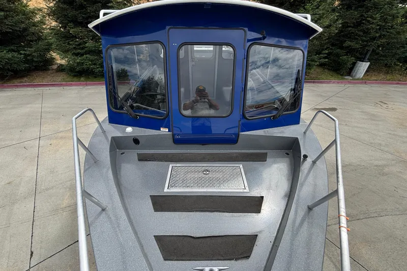 Slide: The Image of 2025 Spartan 240 Maximus Pro boat with blue cabin and sleek design. - 8