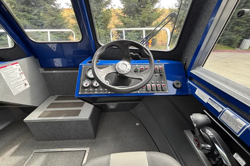 Slide: The Image of Interior cockpit of 2025 Spartan 240 Maximus Pro boat with steering wheel and control panel. - 18