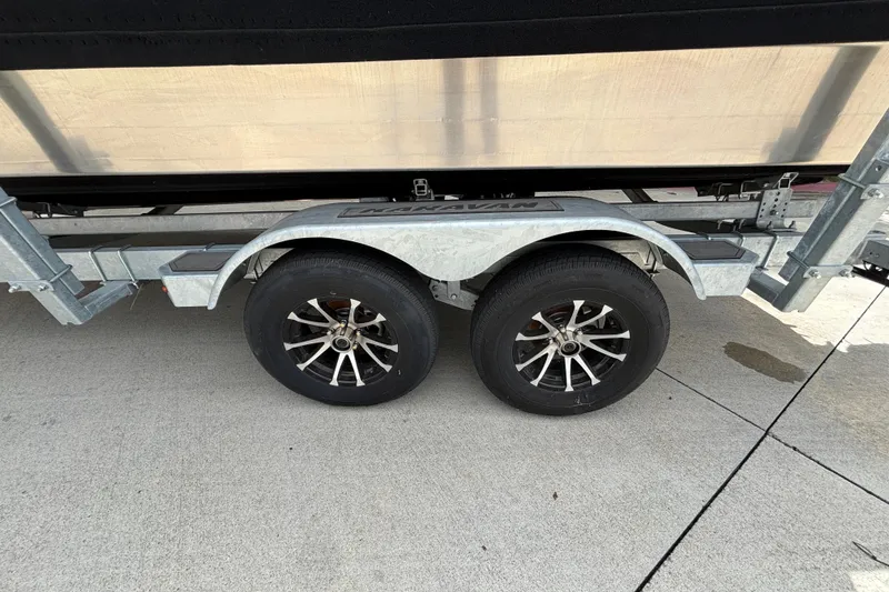 Slide: The Image of 2025 Spartan 240 Maximus Pro trailer wheels on concrete surface. - 35