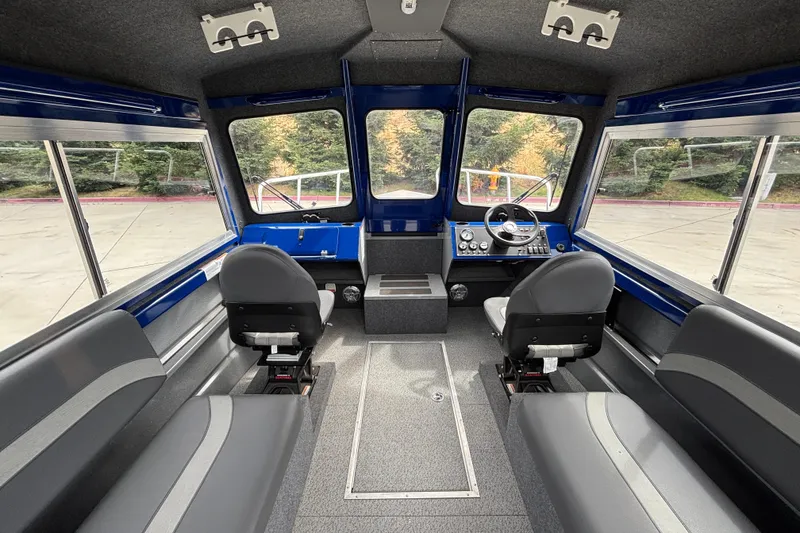 Slide: The Image of Interior of 2025 Spartan 240 Maximus Pro boat with modern seating and control panel. - 14