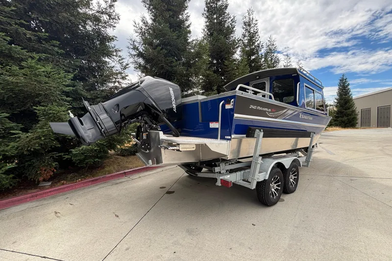Slide: The Image of 2025 Spartan 240 Maximus Pro boat on trailer, featuring powerful outboard motor. - 5