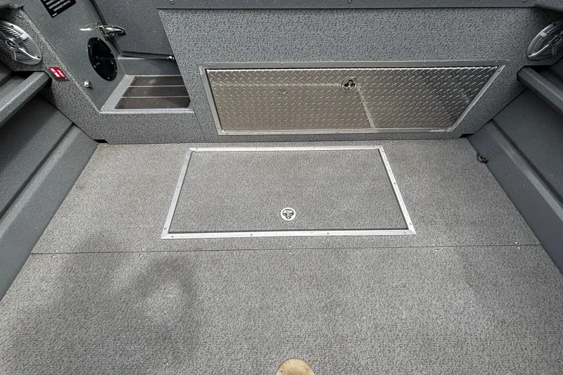 Slide: The Image of Interior of 2025 Spartan 240 Maximus Pro boat, featuring storage compartments and durable flooring. - 24