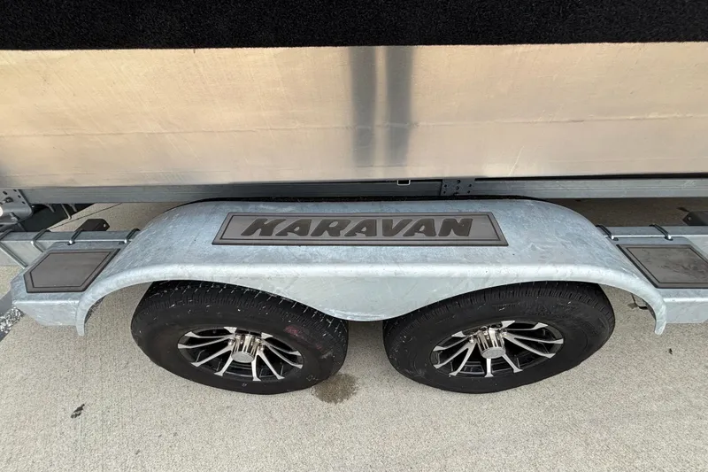 Slide: The Image of Trailer with dual wheels and "Karavan" branding, part of Spartan 240 Maximus Pro, 2025 model. - 38