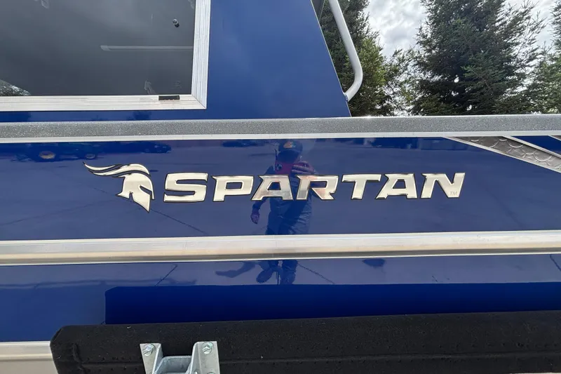 Slide: The Image of 2025 Spartan 240 Maximus Pro boat with sleek blue exterior and bold logo design. - 9