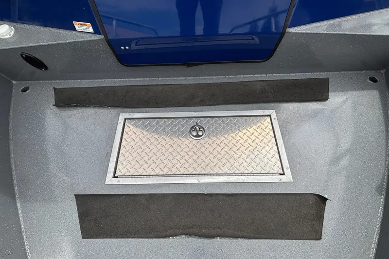 Slide: The Image of Interior view of 2025 Spartan 240 Maximus Pro boat with diamond plate hatch. - 30