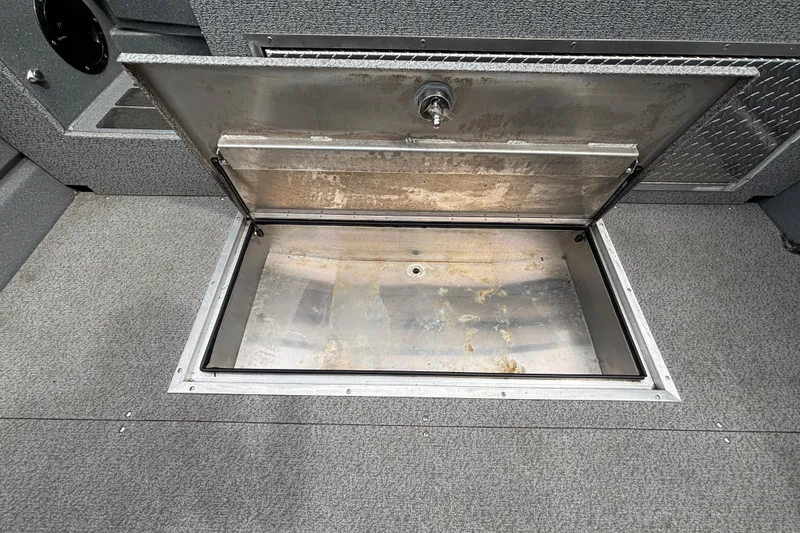 Slide: The Image of Open storage compartment in 2025 Spartan 240 Maximus Pro boat interior. - 27