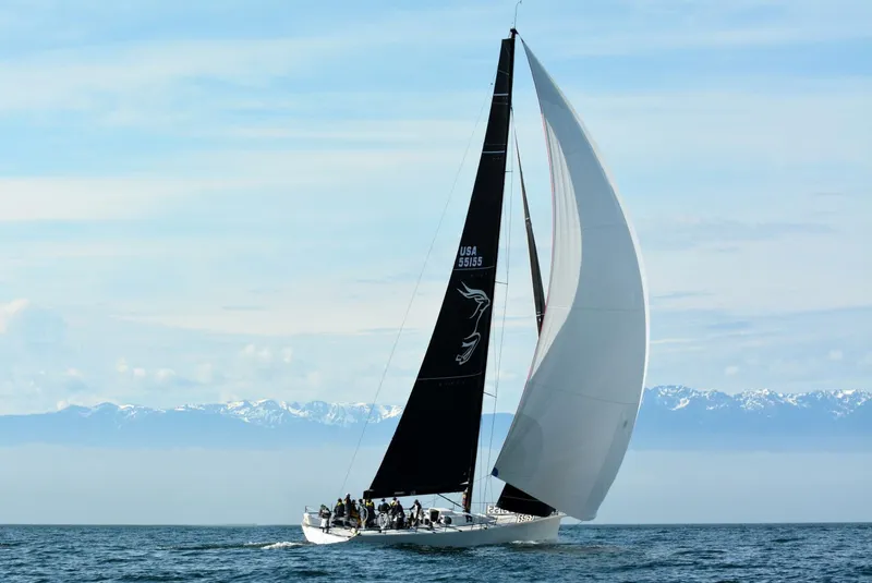 Slide: The Image of Sailing yacht McConaghy Reichel/Pugh 2007 on open sea with mountains in background. - 0