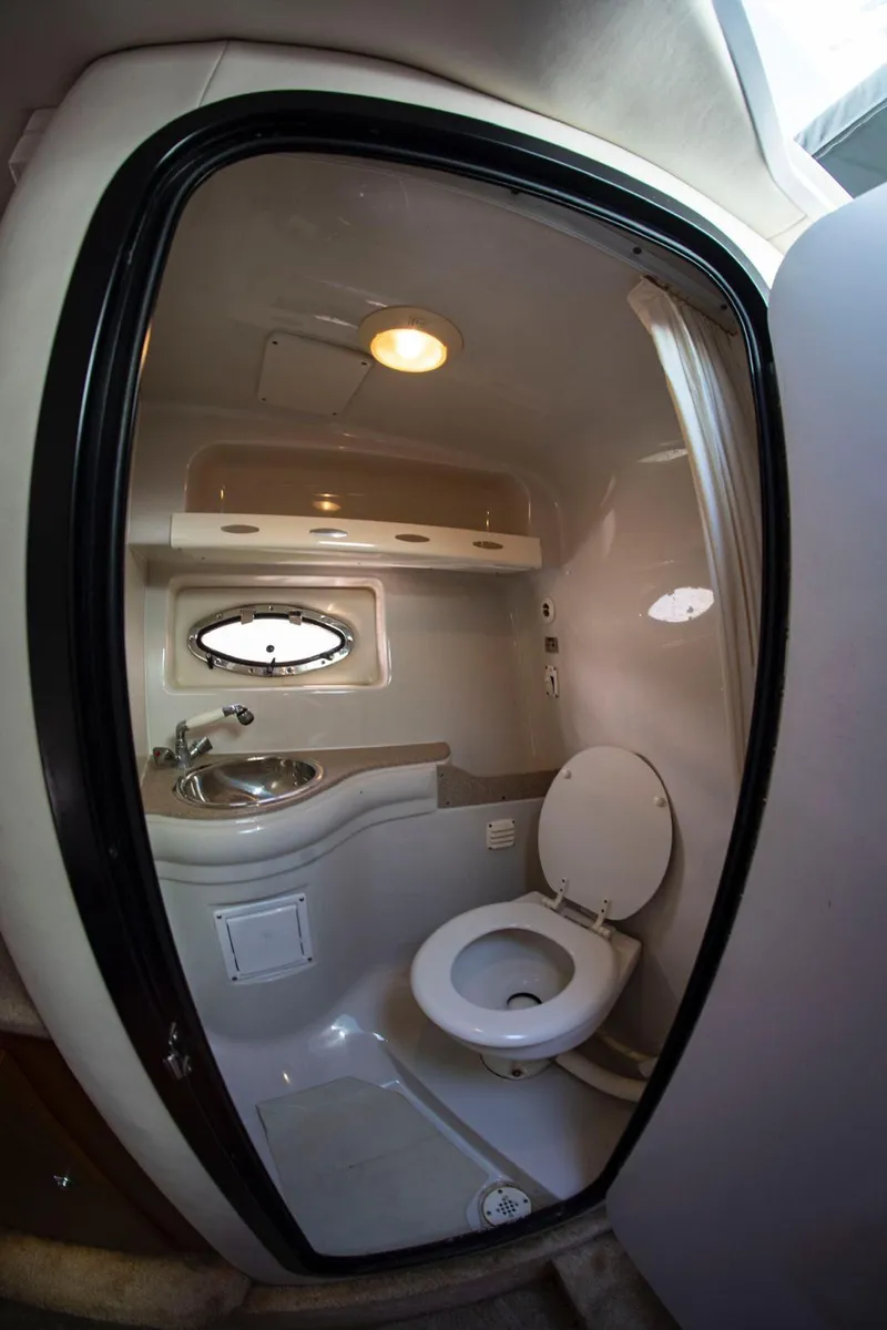Slide: The Image of 2006 Crownline 320 LS boat bathroom interior with sink and toilet. - 10
