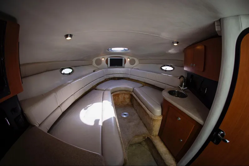 Slide: The Image of Interior of 2006 Crownline 320 LS boat with seating and kitchenette. - 13