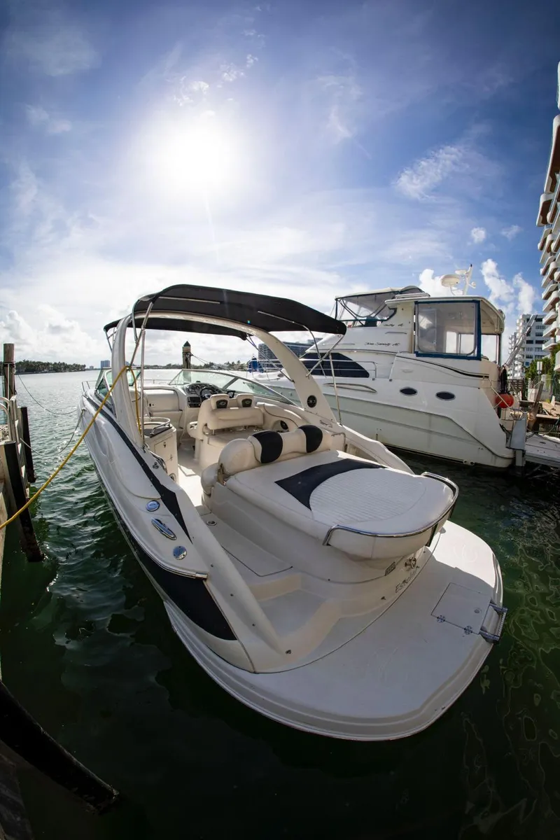 Slide: The Image of 2006 Crownline 320 LS boat docked under a bright blue sky. - 14