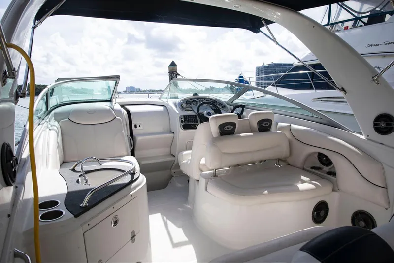 Slide: The Image of 2006 Crownline 320 LS boat interior with white seating and dashboard. - 17