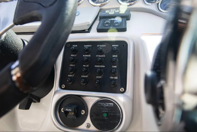 Slide: The Image of Control panel of a 2006 Crownline 320 LS boat, featuring various switches and dials. - 21