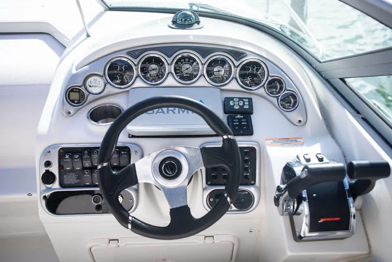 Slide: The Image of Dashboard of a 2006 Crownline 320 LS boat with steering wheel and controls. - 22