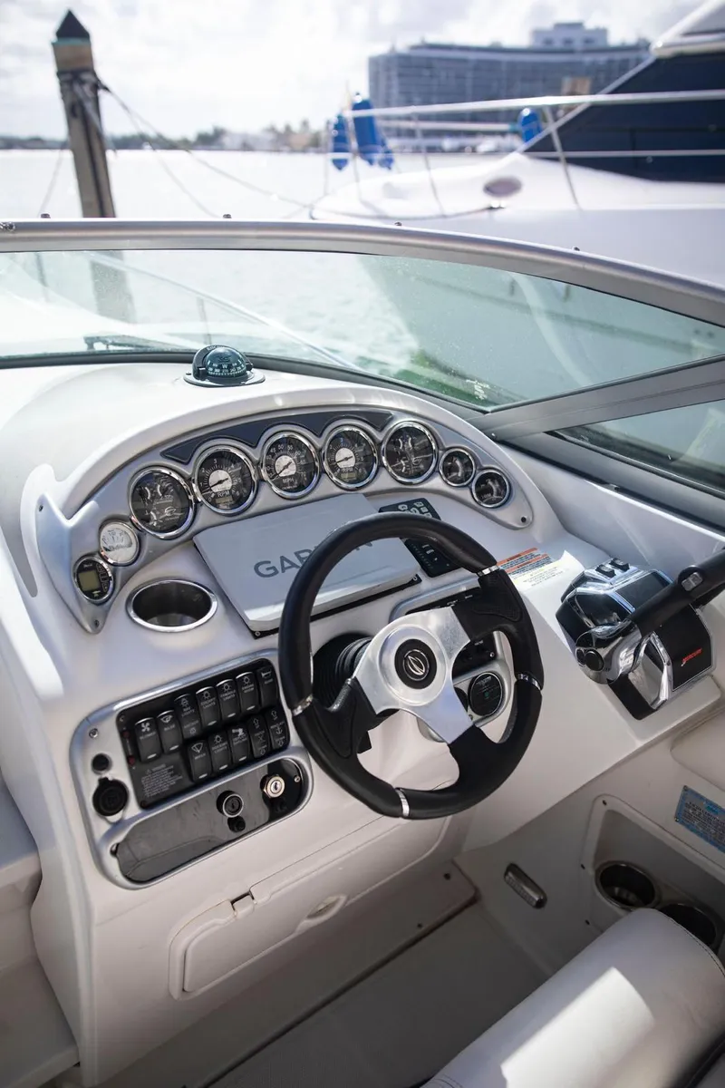Slide: The Image of 2006 Crownline 320 LS boat dashboard with steering wheel and gauges. - 24