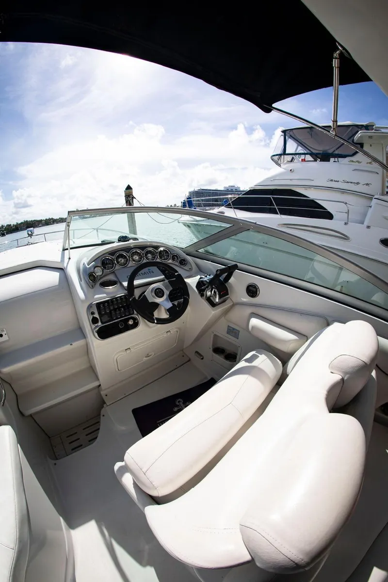 Slide: The Image of 2006 Crownline 320 LS boat interior with steering wheel and white seating. - 25