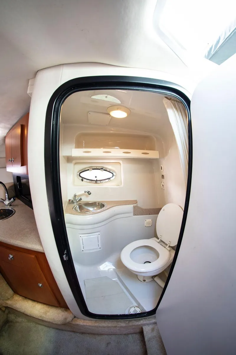 Slide: The Image of 2006 Crownline 320 LS boat bathroom interior with sink and toilet. - 8