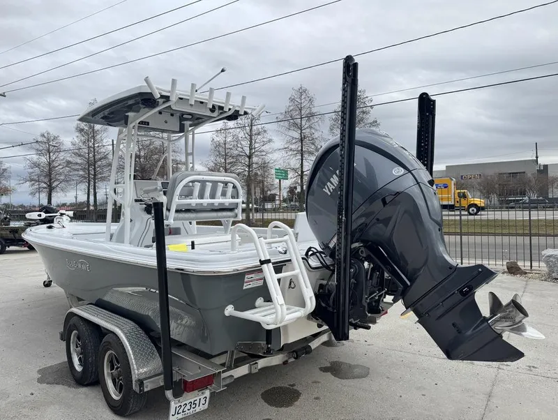 Slide: The Image of 2024 Blue Wave 2400 PURE BAY boat on trailer with Yamaha outboard motor. - 13