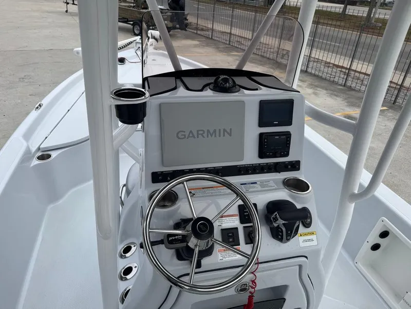 Slide: The Image of 2024 Blue Wave 2400 PURE BAY boat console with Garmin navigation system and steering wheel. - 15