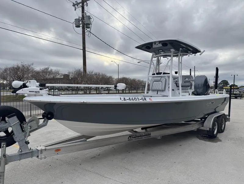 Slide: The Image of 2024 Blue Wave 2400 PURE BAY boat on trailer, overcast sky background. - 3