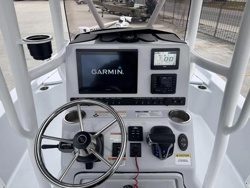 Slide: The Image of 2024 Blue Wave 2400 PURE BAY boat dashboard with Garmin display and steering wheel. - 7