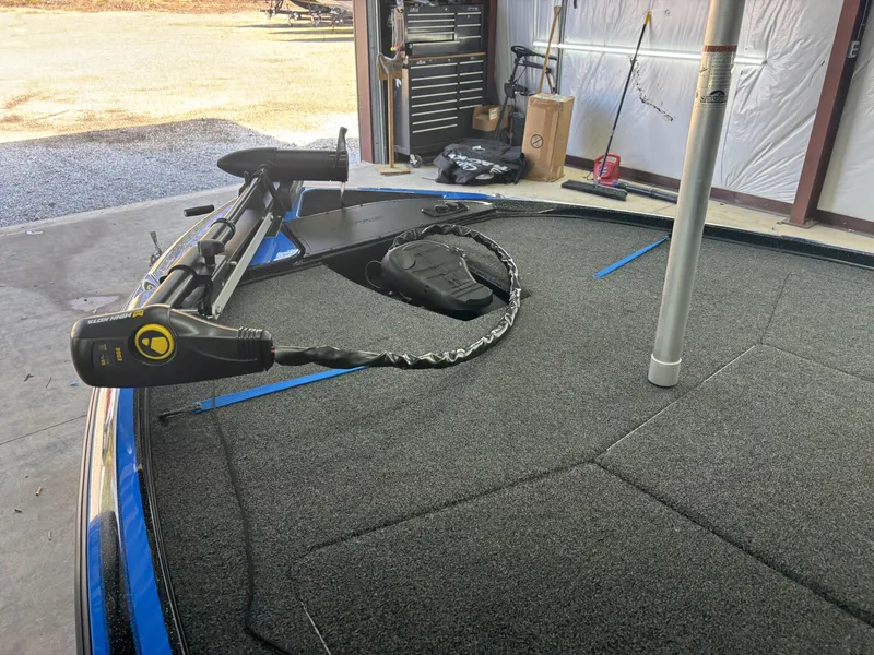 Slide: The Image of 2023 Nitro Z17 boat deck with trolling motor in a garage setting. - 10