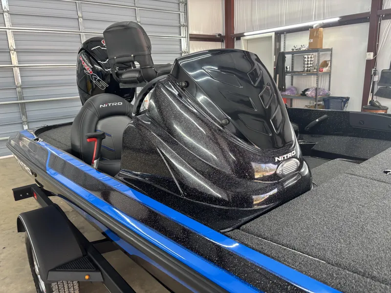 Slide: The Image of 2023 Nitro Z17 boat with sleek black design in a garage setting. - 11