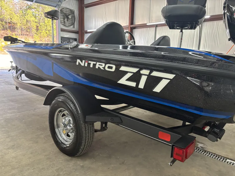 Slide: The Image of 2023 Nitro Z17 boat in a garage, featuring sleek black and blue design. - 14