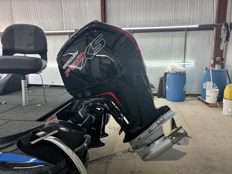 Slide: The Image of 2023 Nitro Z17 boat with Mercury Pro XS outboard motor in a garage setting. - 15
