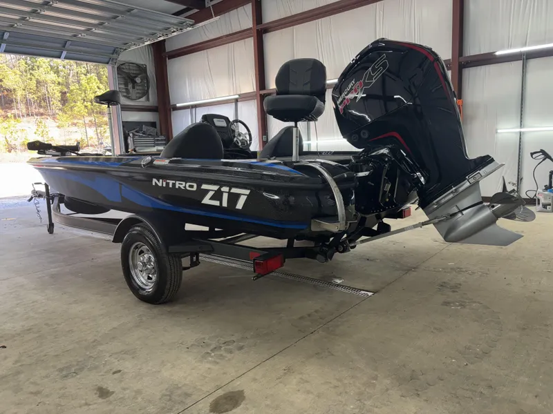 Slide: The Image of 2023 Nitro Z17 boat in garage, featuring sleek design and powerful outboard motor. - 3