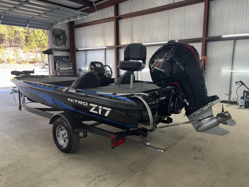 Slide: The Image of 2023 Nitro Z17 boat in a garage, featuring a powerful outboard motor. - 4