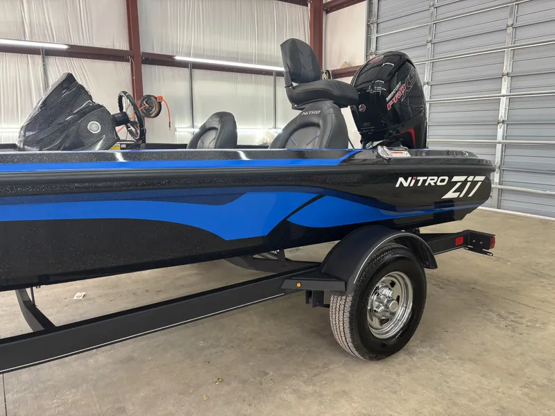 Slide: The Image of 2023 Nitro Z17 boat in a garage, featuring blue and black design. - 6