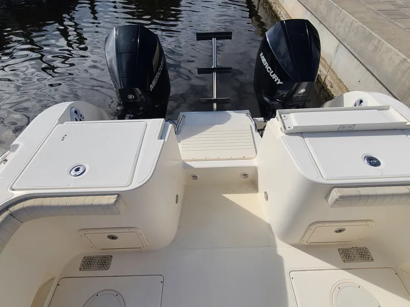 Slide: The Image of 2008 World Cat 270 TE boat with dual Mercury engines, docked by the water. - 26