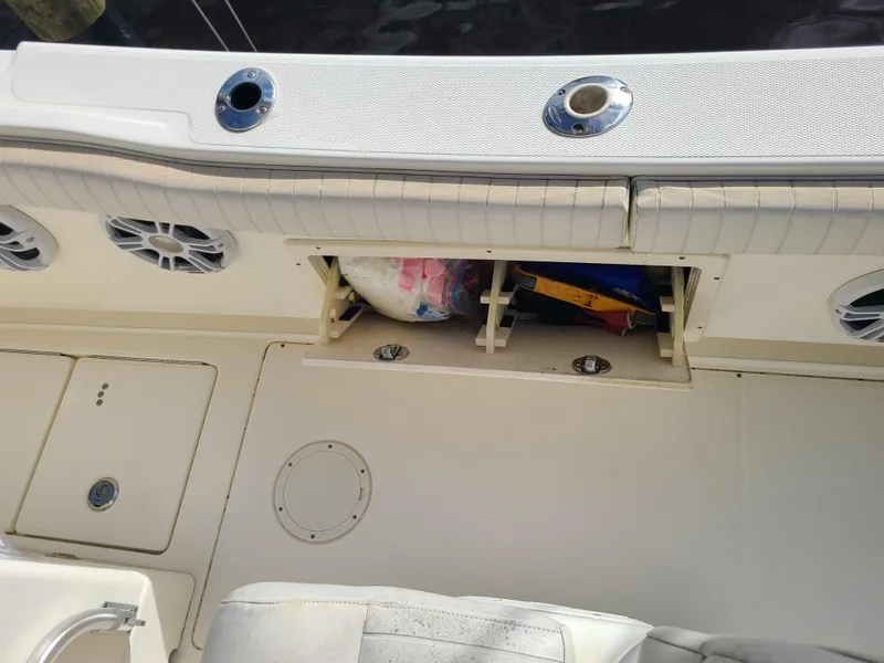 Slide: The Image of 2008 World Cat 270 TE boat interior with storage compartment and speakers. - 39
