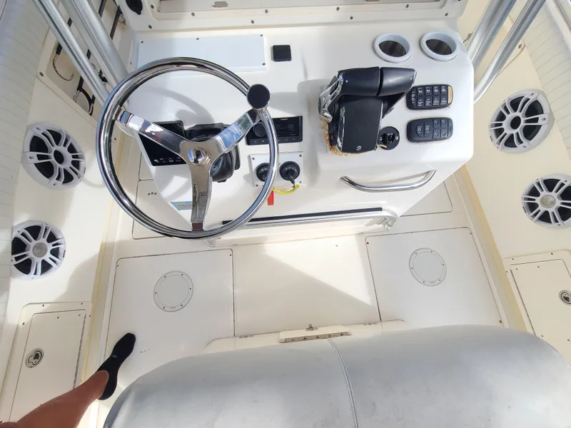 Slide: The Image of 2008 World Cat 270 TE boat helm with steering wheel and control panel. - 42