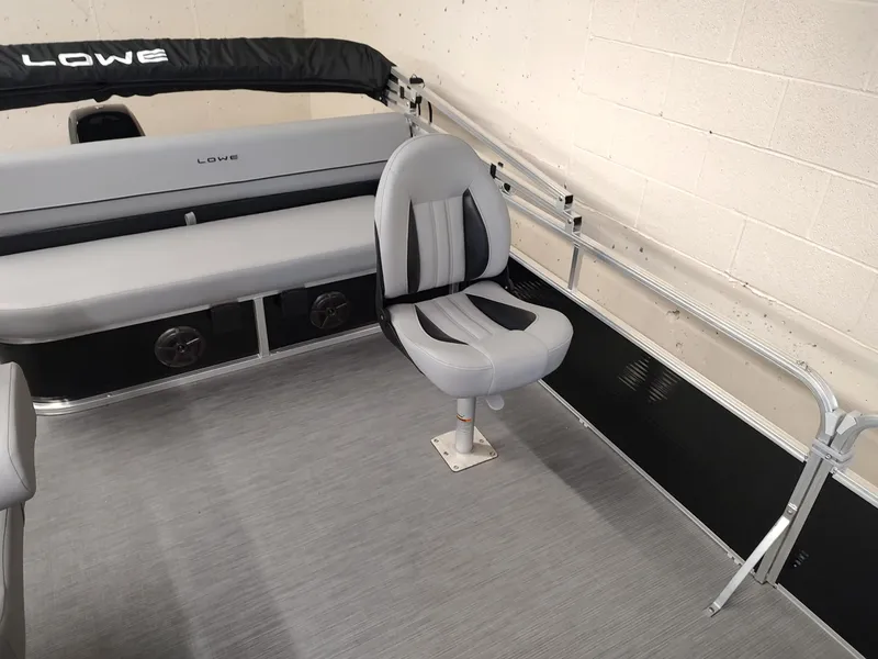 Slide: The Image of 2025 Lowe UC180 boat interior with gray seating and railing. - 10