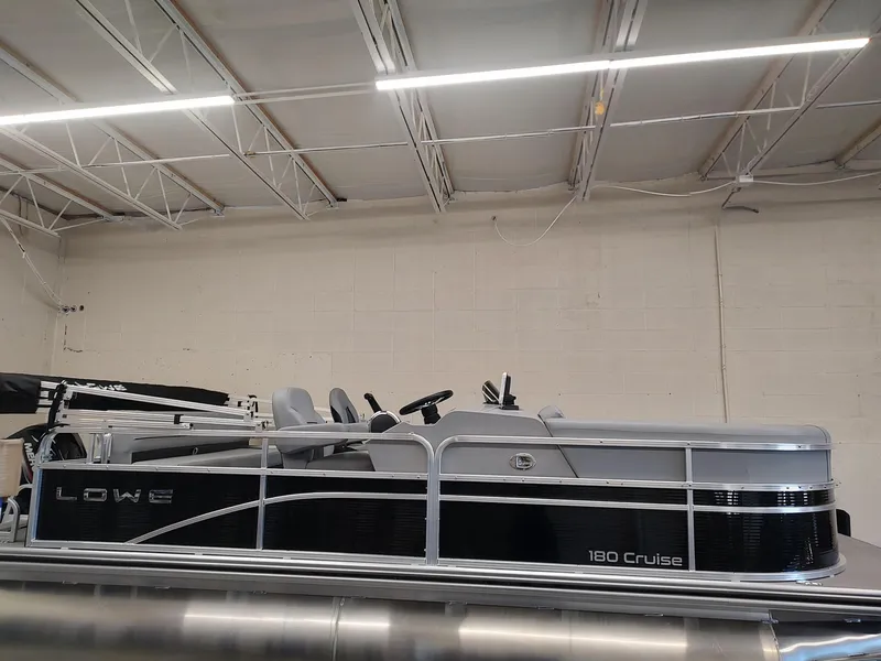 Slide: The Image of 2025 Lowe UC180 pontoon boat in showroom, side view. - 3