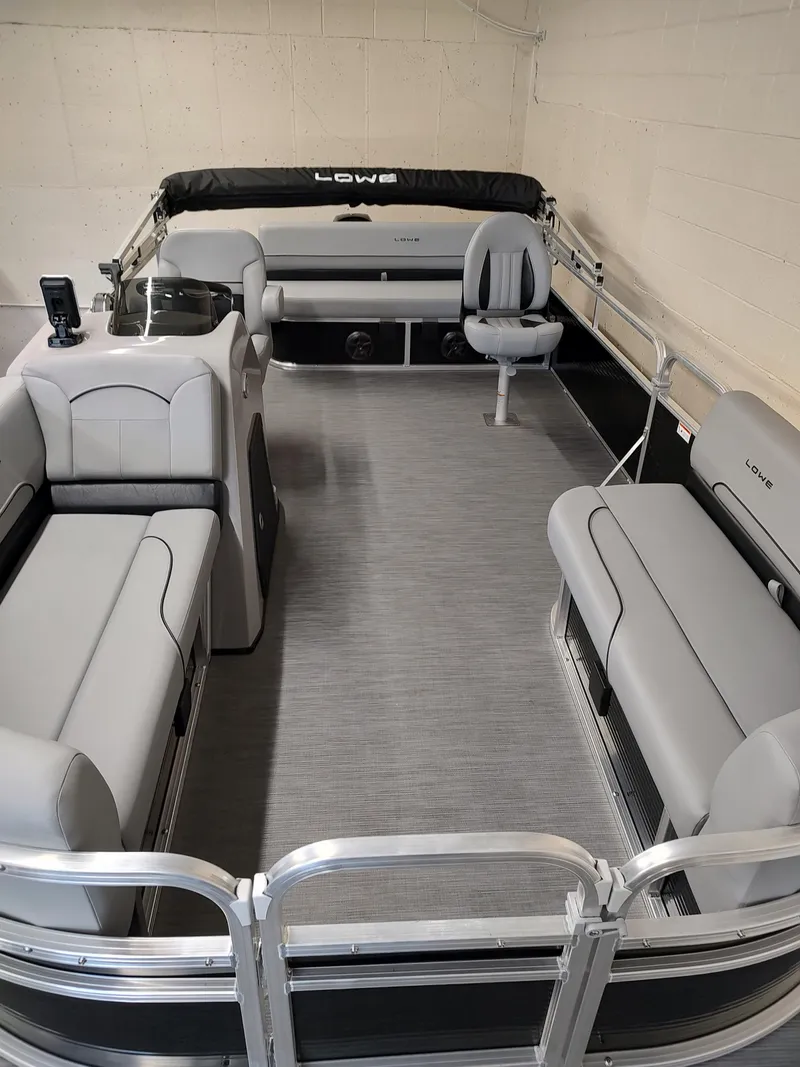 Slide: The Image of 2025 Lowe UC180 pontoon boat interior with gray seating and modern design. - 5