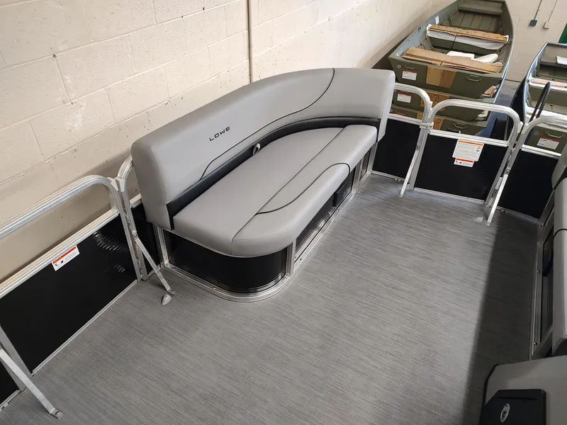 Slide: The Image of 2025 Lowe UC180 boat interior with gray seating and aluminum railings. - 7