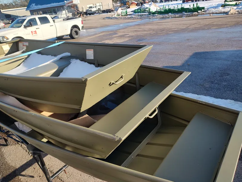 Slide: The Image of 2025 Lowe Jon L1032 boat with snow, parked outdoors near a white truck. - 10