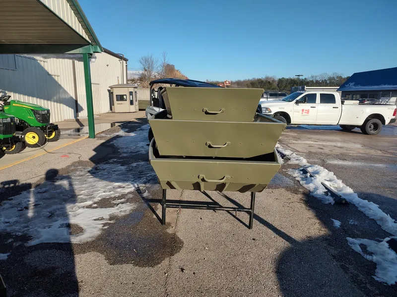 Slide: The Image of Stacked Lowe Jon L1032 boats, 2025 model, in a snowy outdoor setting. - 2