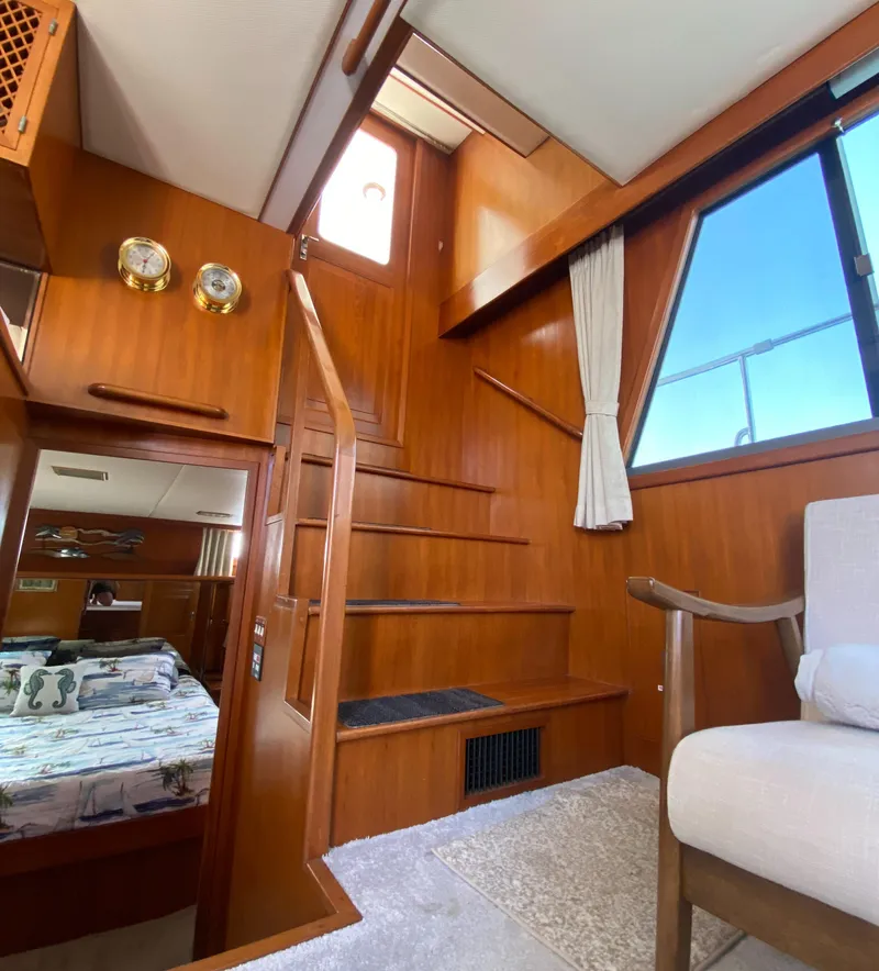 Slide: The Image of 1991 Lien Hwa McKinna 42 Aft Cabin interior with wooden stairs and cozy seating area. - 37