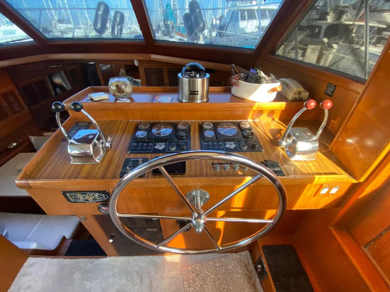 Slide: The Image of 1991 Lien Hwa McKinna 42 Aft Cabin helm with wooden dashboard and steering wheel. - 39