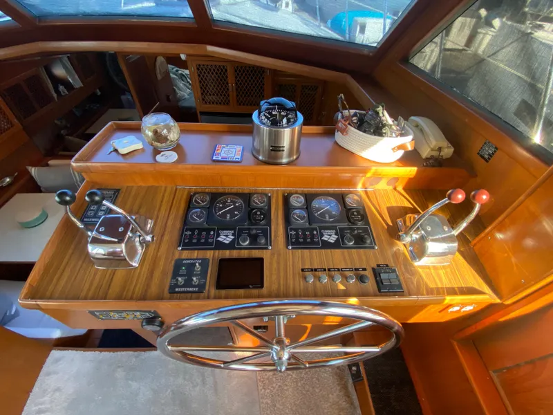 Slide: The Image of 1991 Lien Hwa McKinna 42 Aft Cabin helm with wooden dashboard and navigation controls. - 40